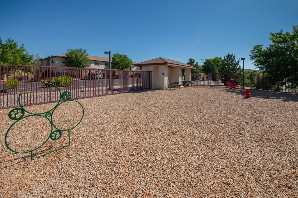 a tennis court with a tennis racket in front of a house