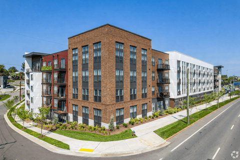 A modern multi-story building with a mix of brick and white exterior walls.