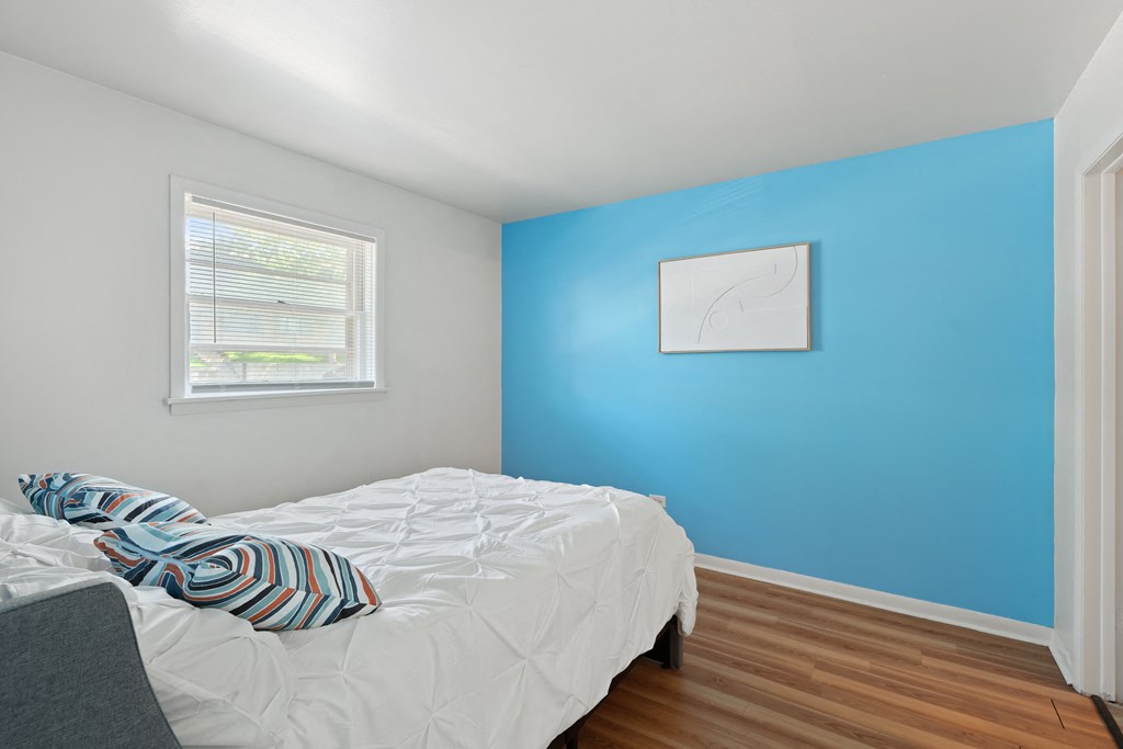 a bedroom with a bed and a window