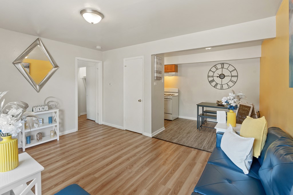 a living room with hardwood floors and a blue couch