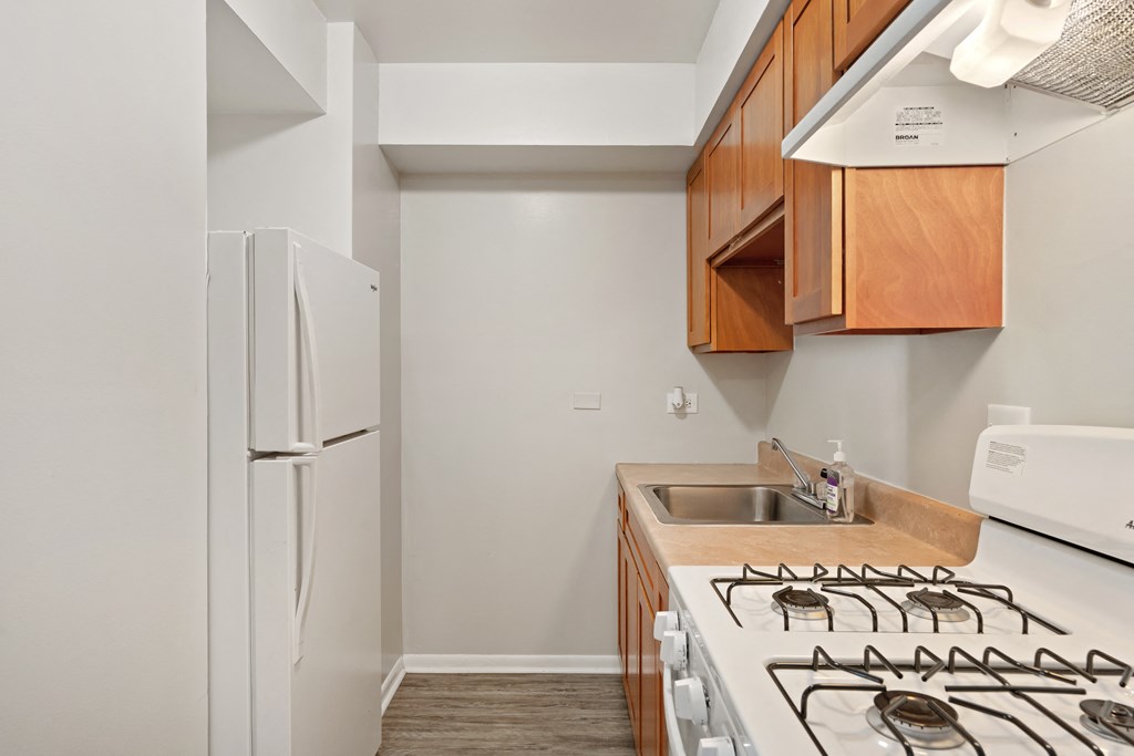 a kitchen with white appliances and wood cabinets
