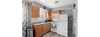 a kitchen with wood cabinets and white appliances