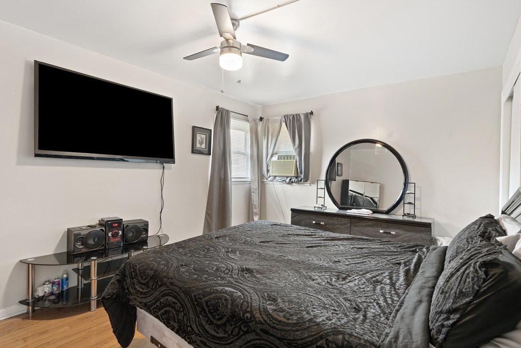 a bedroom with a large bed and a flat screen tv