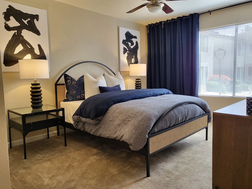 a bedroom with a bed in front of a window