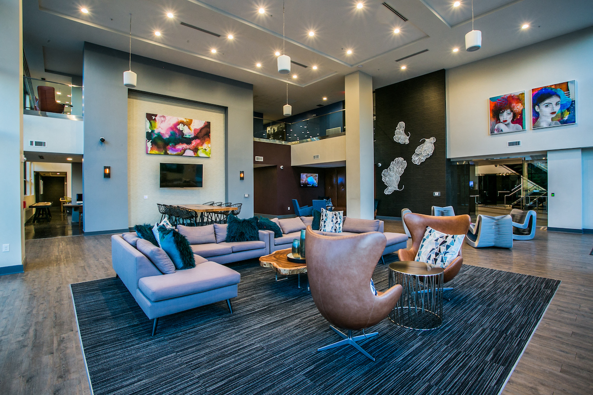 a living room with couches and chairs and a television