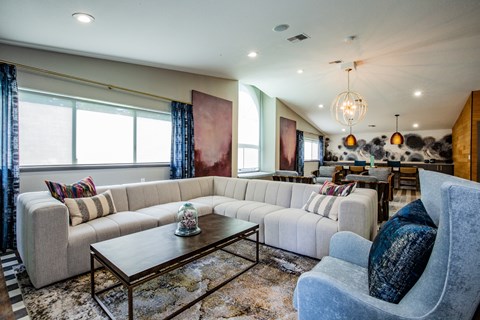A living room with a large sectional sofa and a coffee table.