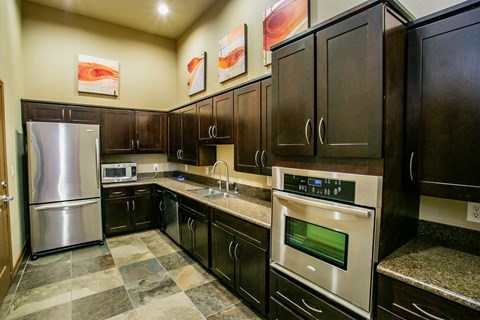 a kitchen with stainless steel appliances and wooden cabinets