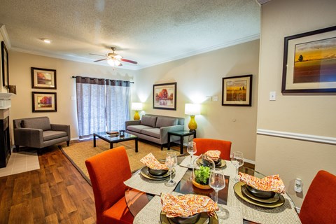 A dining room with a table set for a meal.