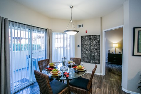 Spacious Apartment Dining Area with Table and Sliding Glass Doors