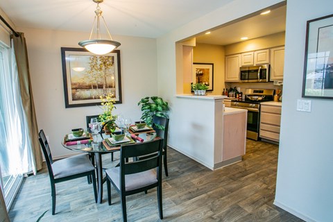 a dining room and kitchen with a table and chairs