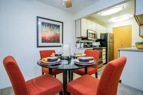 a dining room with a table and chairs and a kitchen