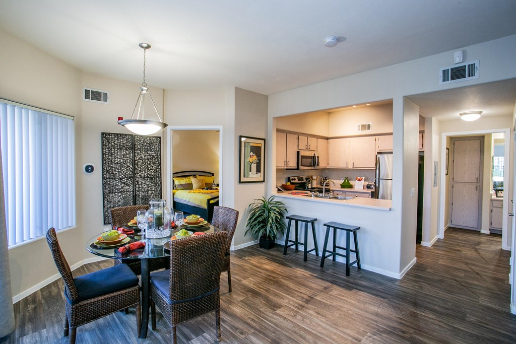 a dining room and kitchen area with a table and chairs in apartment in Las Vegas Nevada