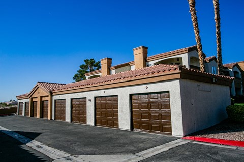 a row of garage doors in front of a house