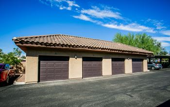 a garage with three garage doors in a parking lot