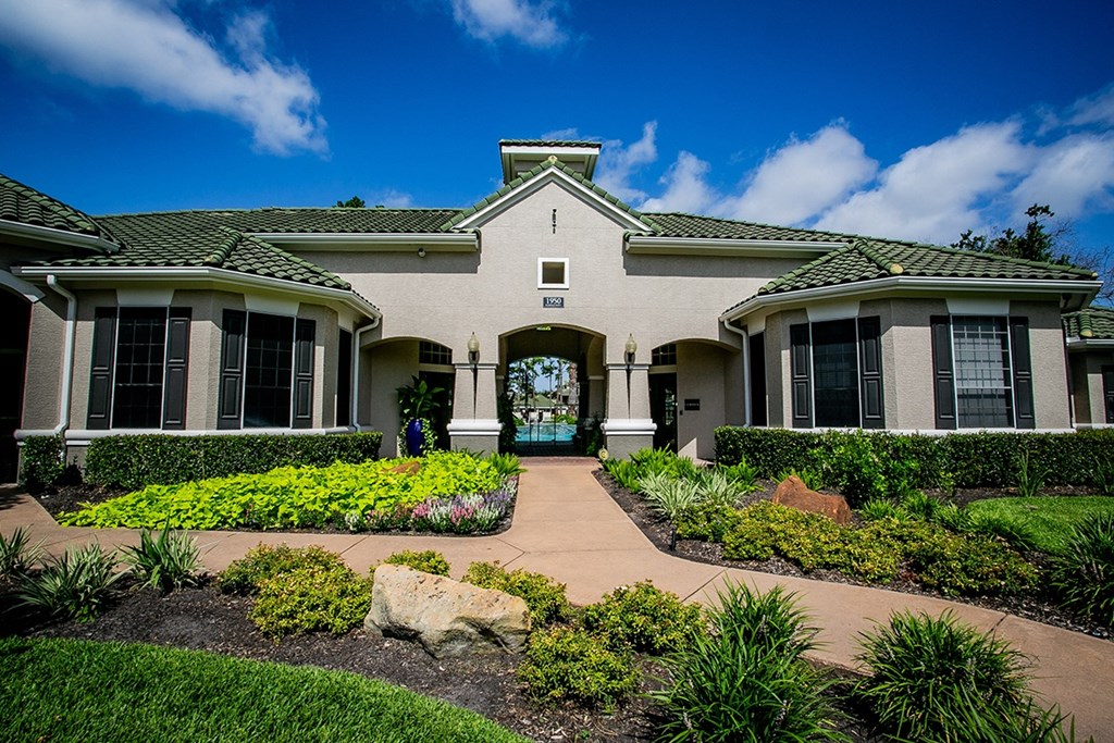 a house with a green door and a blue sky in the background
