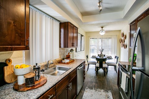 kitchen with stainless steel appliances and granite counter tops and a dining room with a table