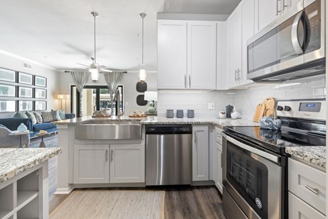 A modern kitchen with a stainless steel dishwasher and oven.
