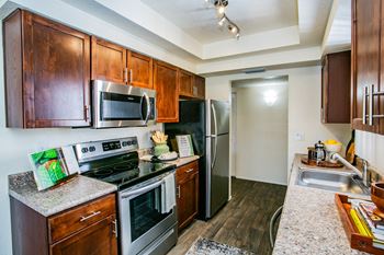 full kitchen with stainless steel appliances and granite counter tops at the reserve at south coast