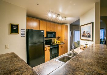 a kitchen with stainless steel appliances and a granite counter top