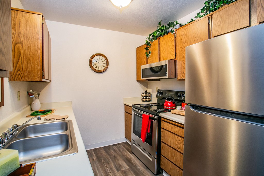 a kitchen with stainless steel appliances and wooden cabinets