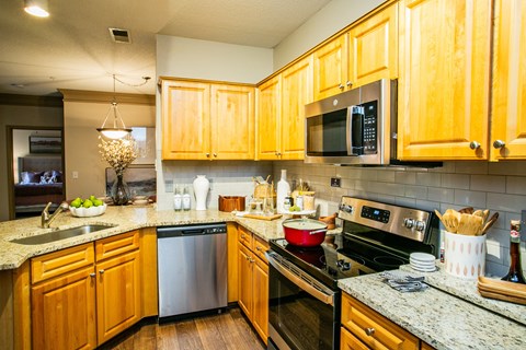 a kitchen with wooden cabinets and stainless steel appliances