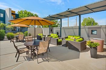 Pool Sundeck with Lounge Chairs and Shade at ABQ Uptown Apartments