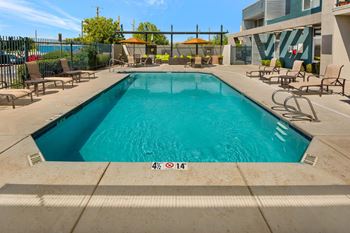 Resort Style Pool with Sun Deck and Lounge Chairs at ABQ Apartments