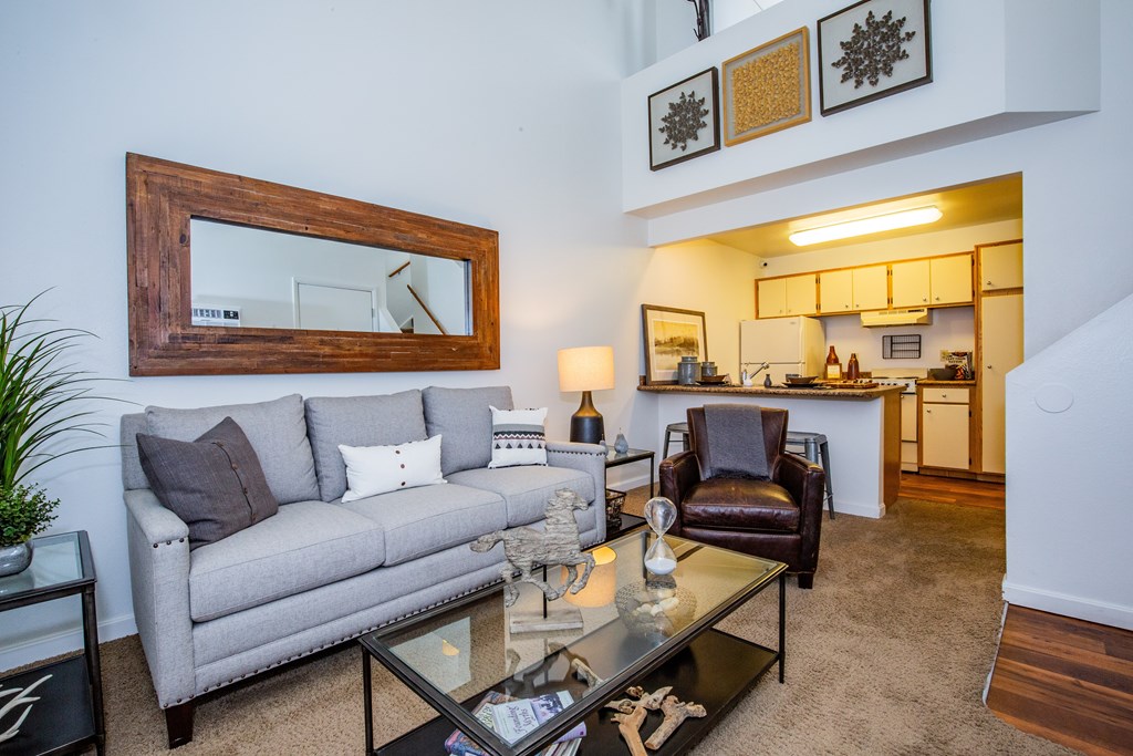 A living room with a grey couch and a coffee table.