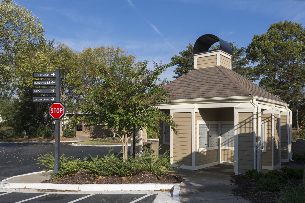 a small building with a stop sign in front of it