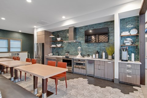 a kitchen and dining area with a table and chairs
