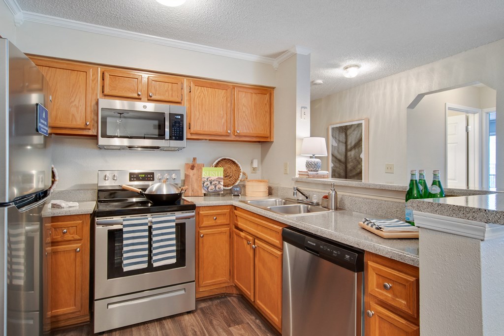 Full Kitchen with Granite Countertops and Stainless Steel Appliances at Luxury Apartments in Duluth GA