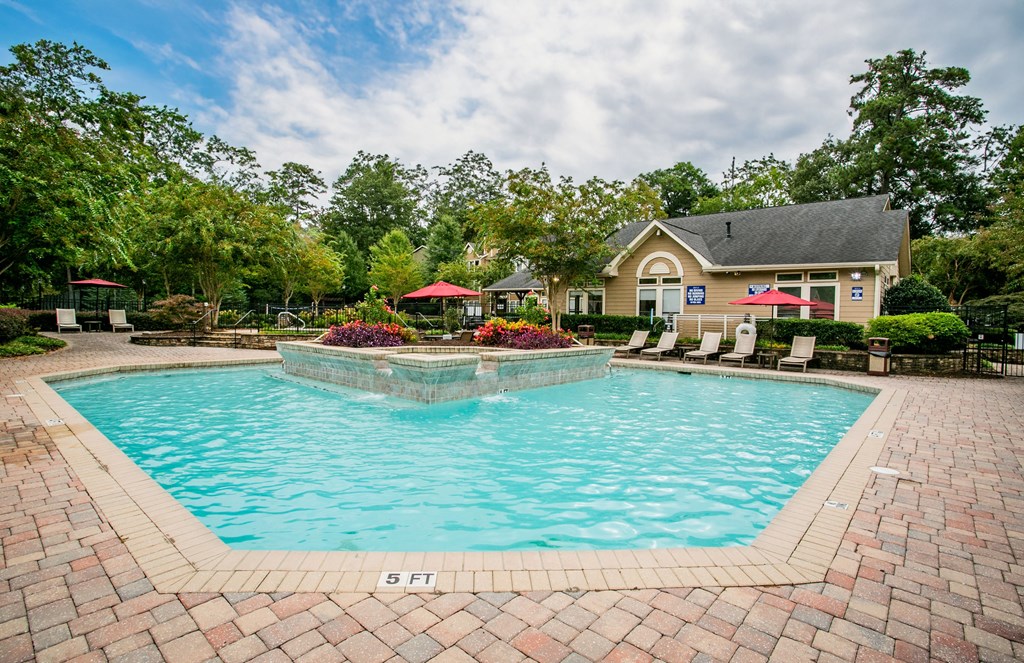 a swimming pool with a house in the background