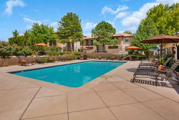 Outdoor Swimming Pool with Sundeck and Lounge Area at Paseo Del Rio Apartments For Rent in Albuquerque, NM