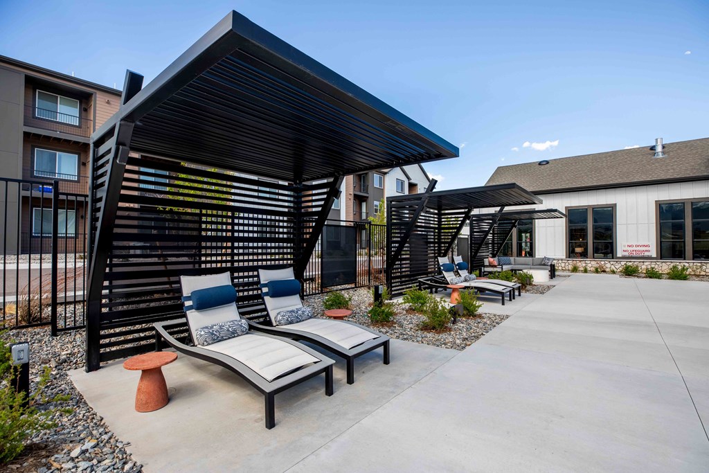 Pool Sundeck with Lounge Chairs and Shade at Colorado Apartments