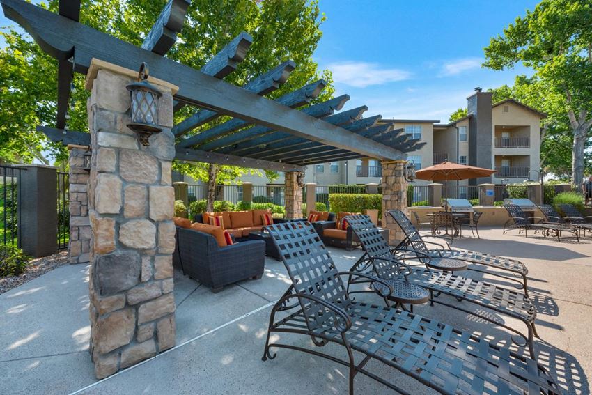 Pool Recliner Chairs Under Pergola at River Walk Apartments - Photo Gallery