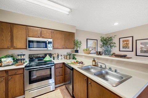 a modern kitchen with stainless steel appliances and wooden cabinets