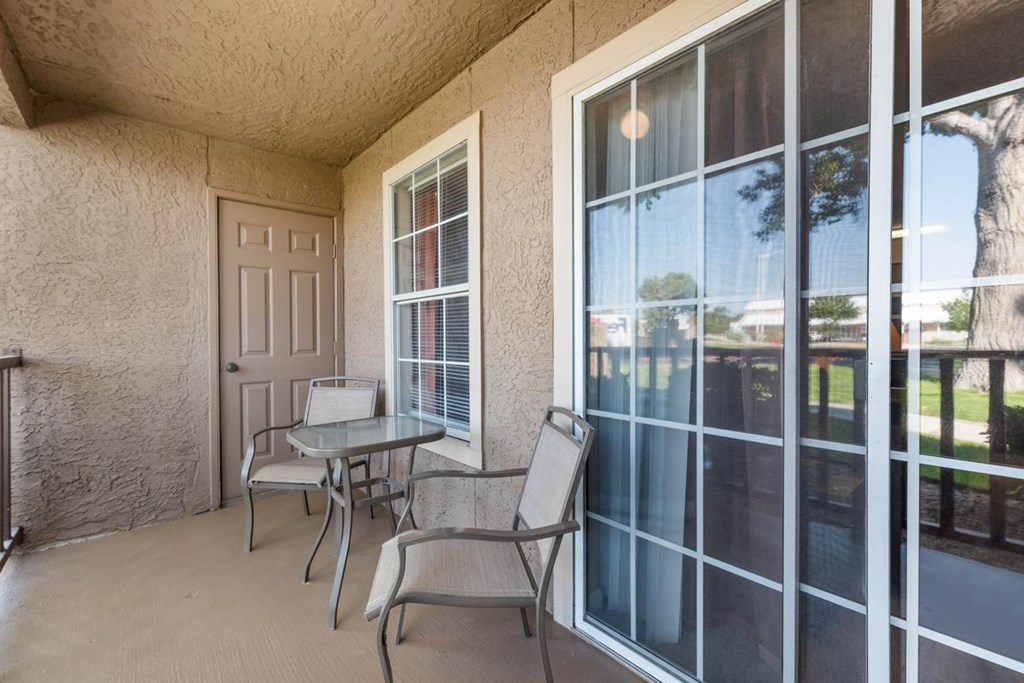 Stucco wall patio with floor to ceiling windows at ABQ Apartments