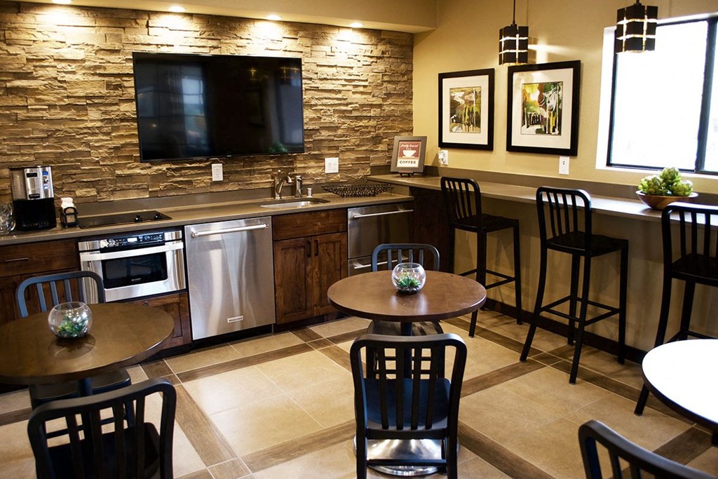 Clubhouse with Stools and Appliances at River Walk Apartments NM