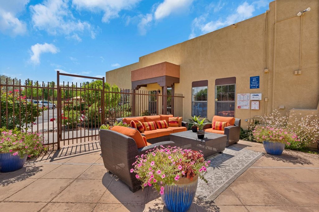 Lounge Area on Pool Deck with Cushion Chairs at Rancho Carrera Apartments NM