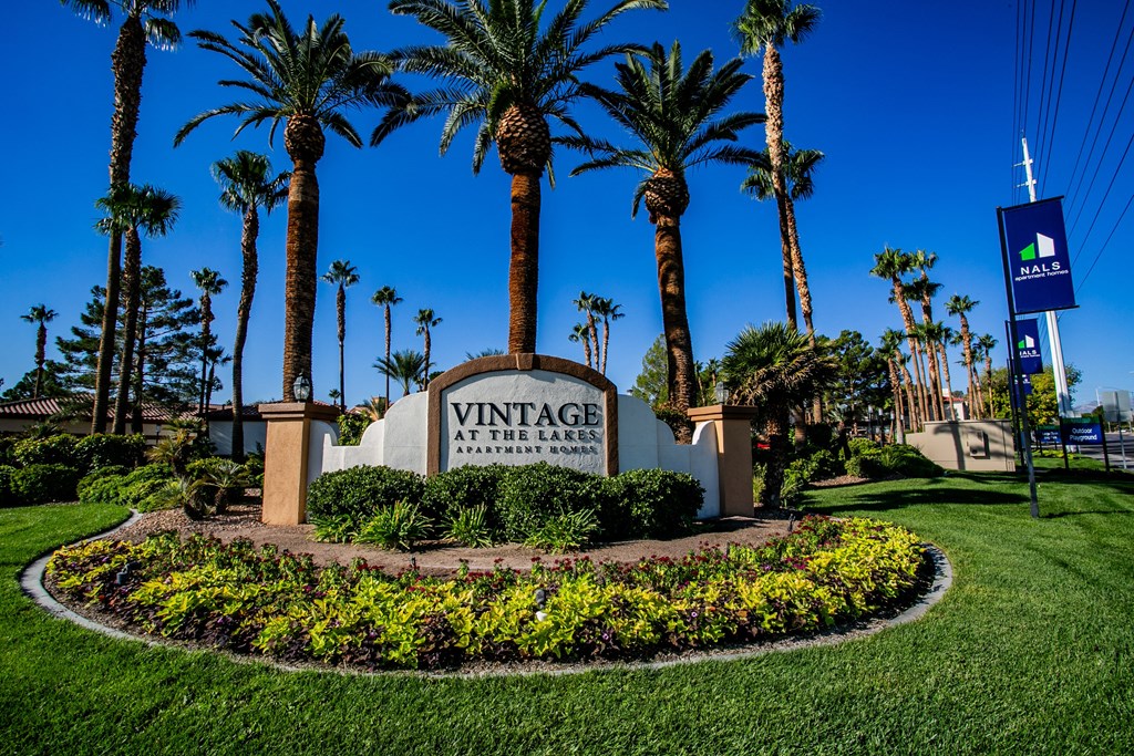 the sign at the entrance of a villa with palm trees
