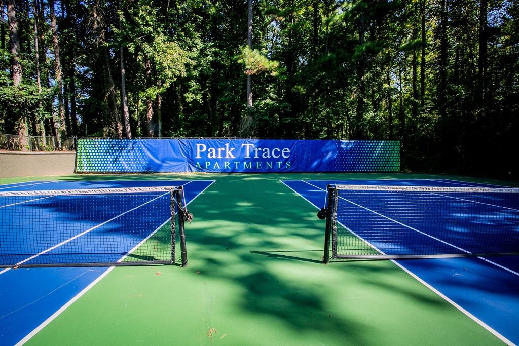 two tennis nets on a tennis court at park trace apartments