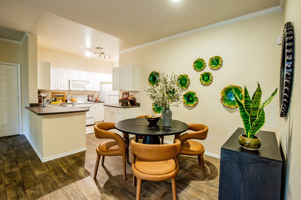 A kitchen with a table and chairs in the middle of the room.