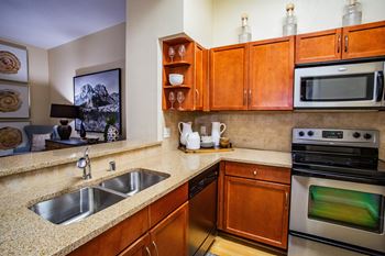 Full Gourmet Kitchens with Stainless Appliances and Cherry Maple Cabinetry at North Phoenix Apartment