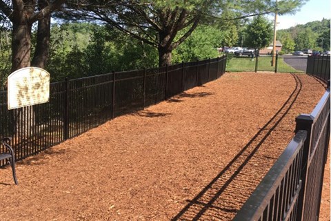 A baseball field with a fence and a sign.