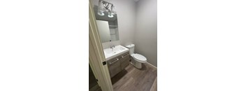 A white toilet sits next to a sink in a small bathroom.