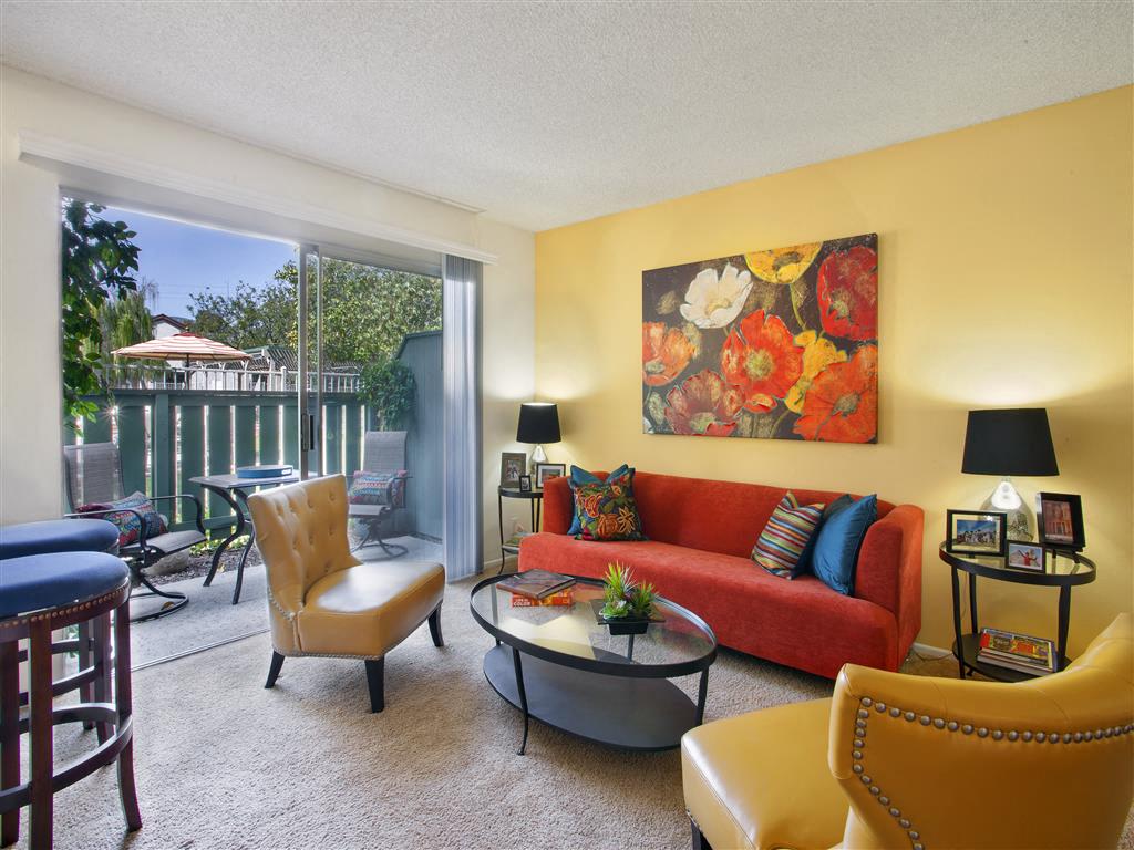 a living room with a red couch and a table