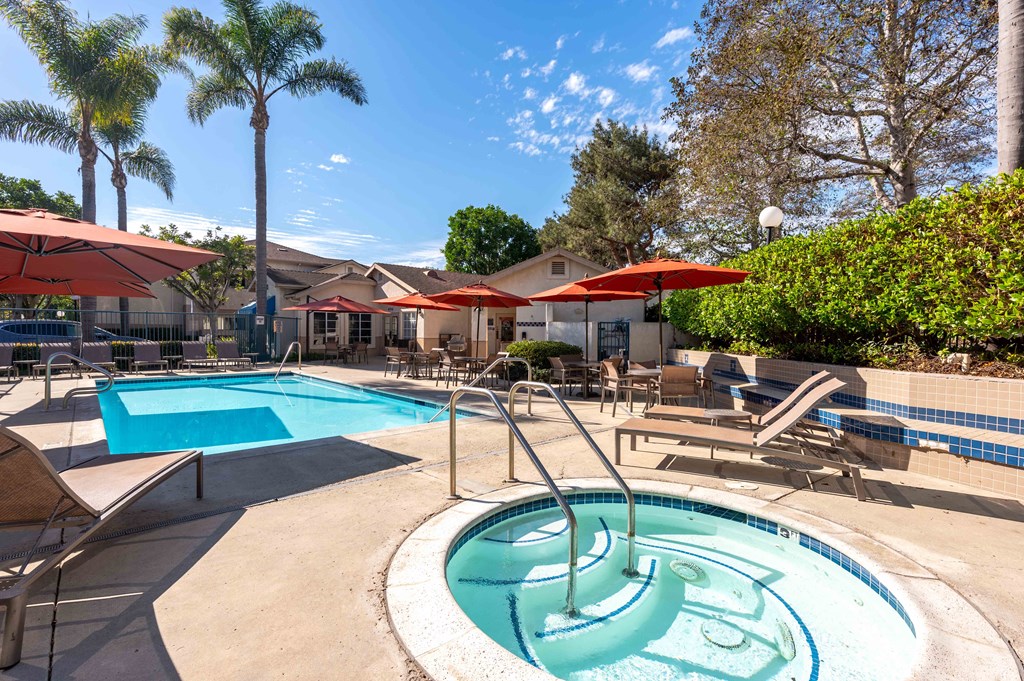 our apartments have a resort style pool with chairs and umbrellas