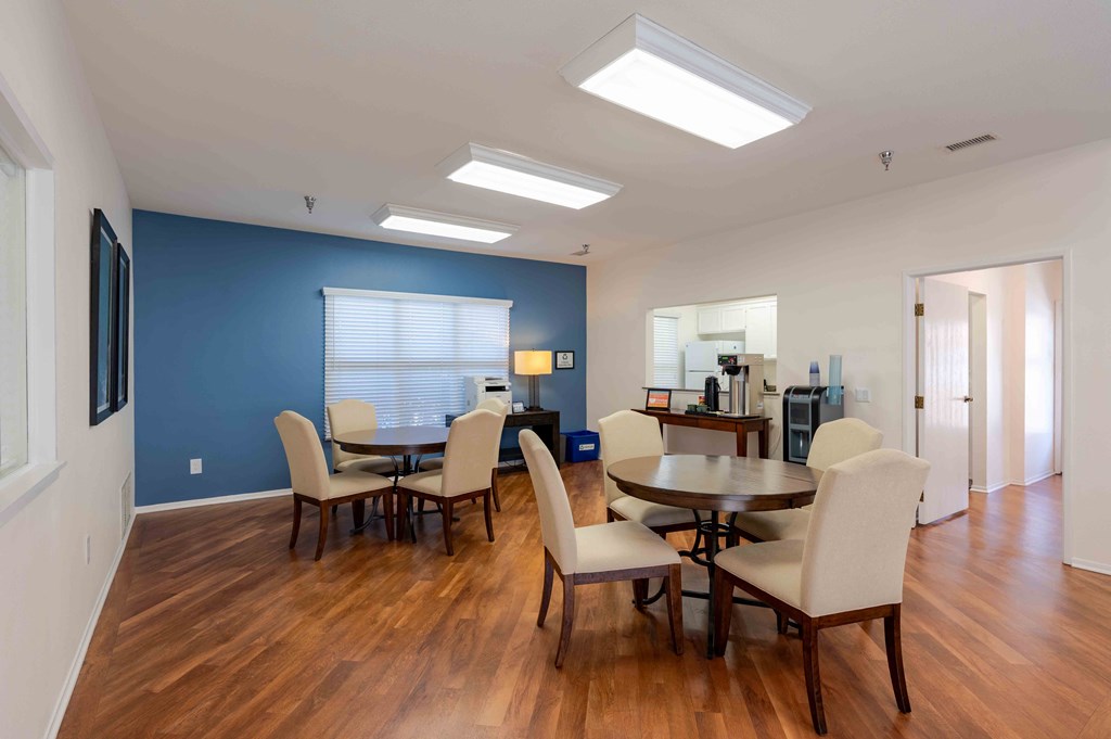 a dining room and living room with a table and chairs