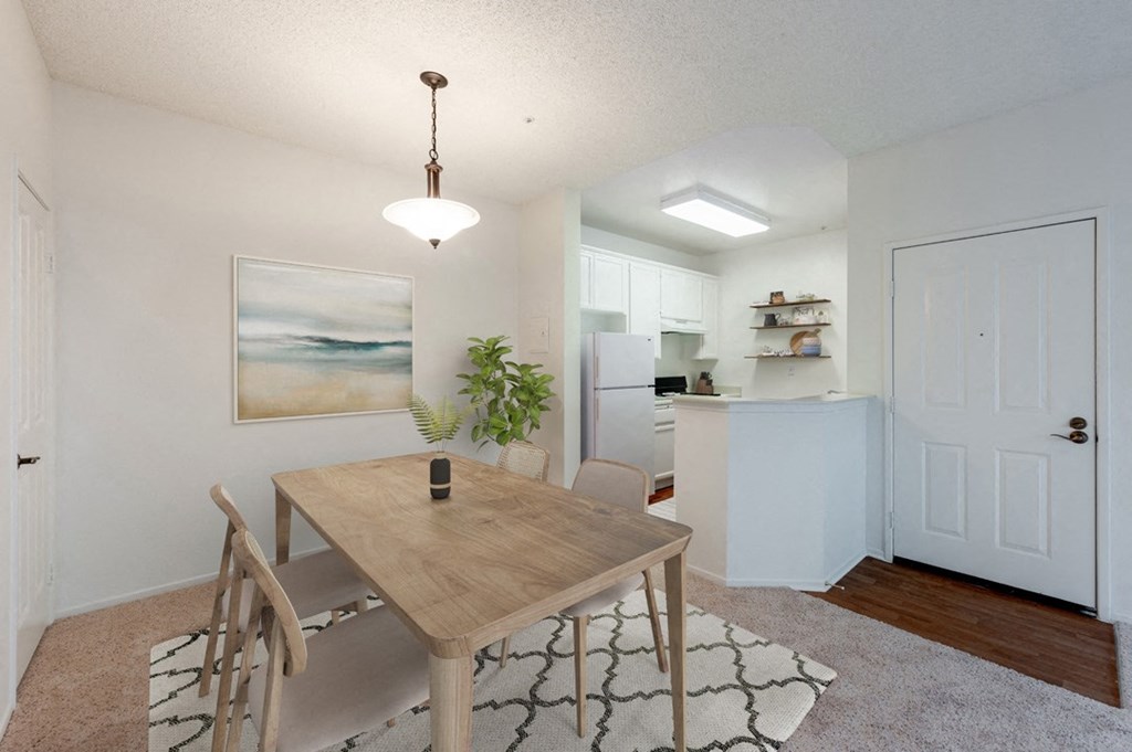 a dining room and kitchen with a table and chairs