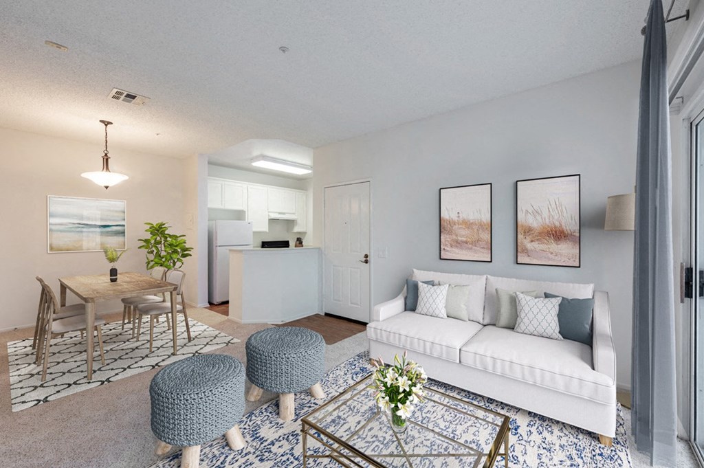 a living room with a white couch and a dining room table